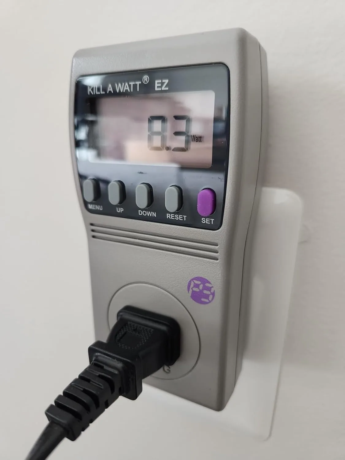 Customer photo of power meter display showing phantom load wattage readings from household devices