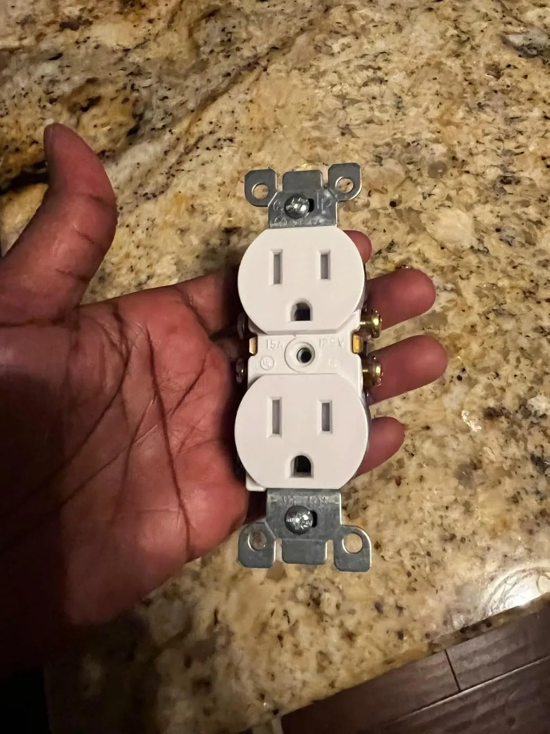 Customer photo of backstab outlet terminals showing failed wire connections