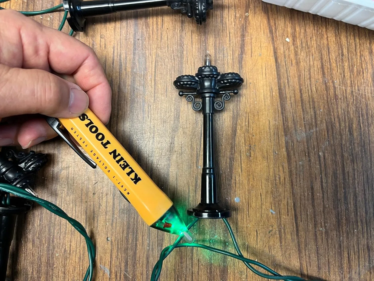 Customer photo of non-contact voltage tester being used to test an electrical outlet