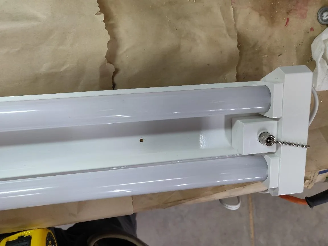 Customer photo of LED shop light installed in garage workshop showing bright white light output