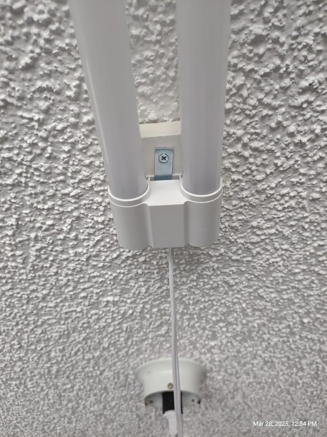 Customer photo of LED shop light installed in garage workspace showing brightness and coverage