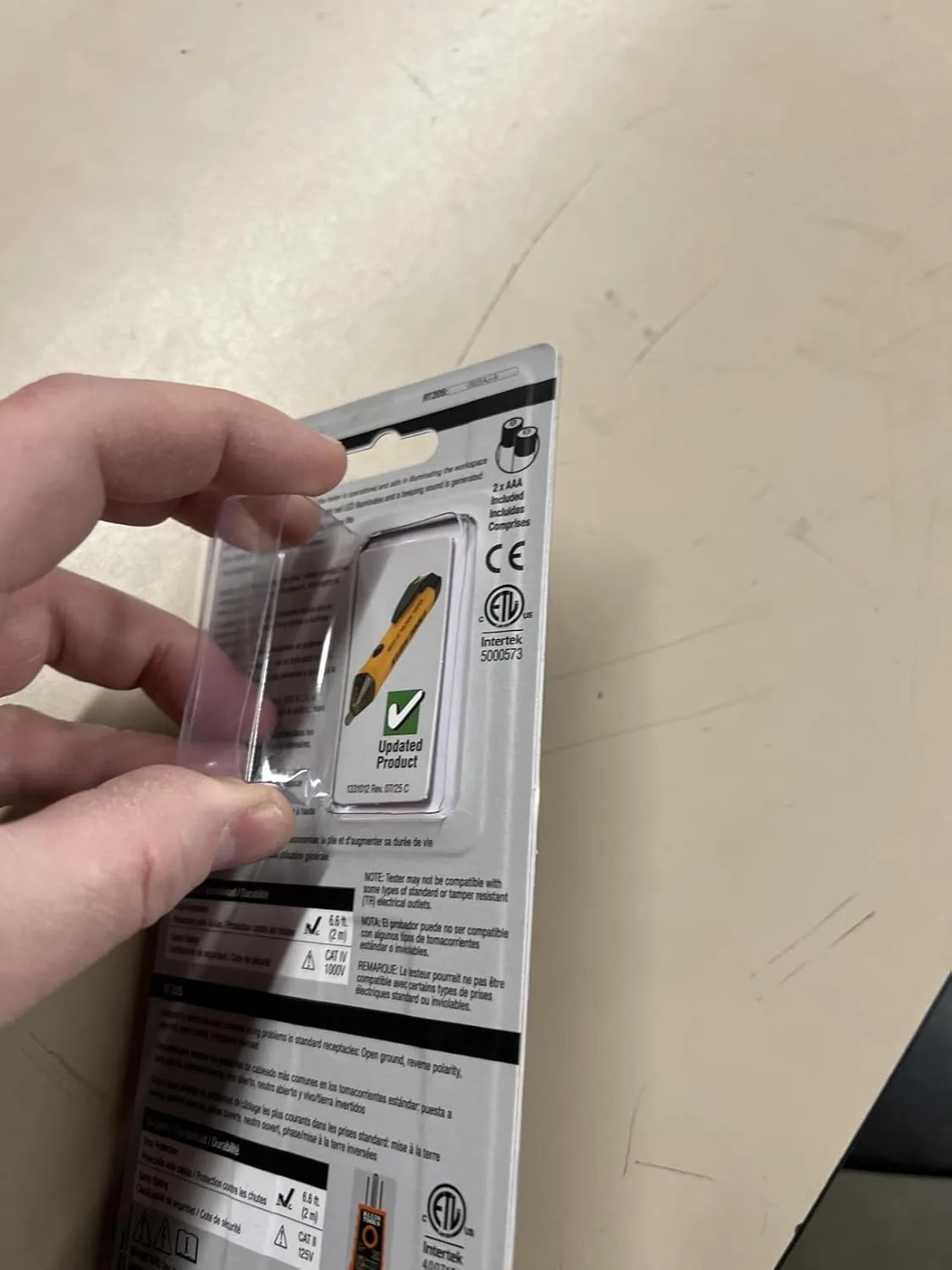Customer photo showing non-contact voltage tester being used to test an electrical outlet