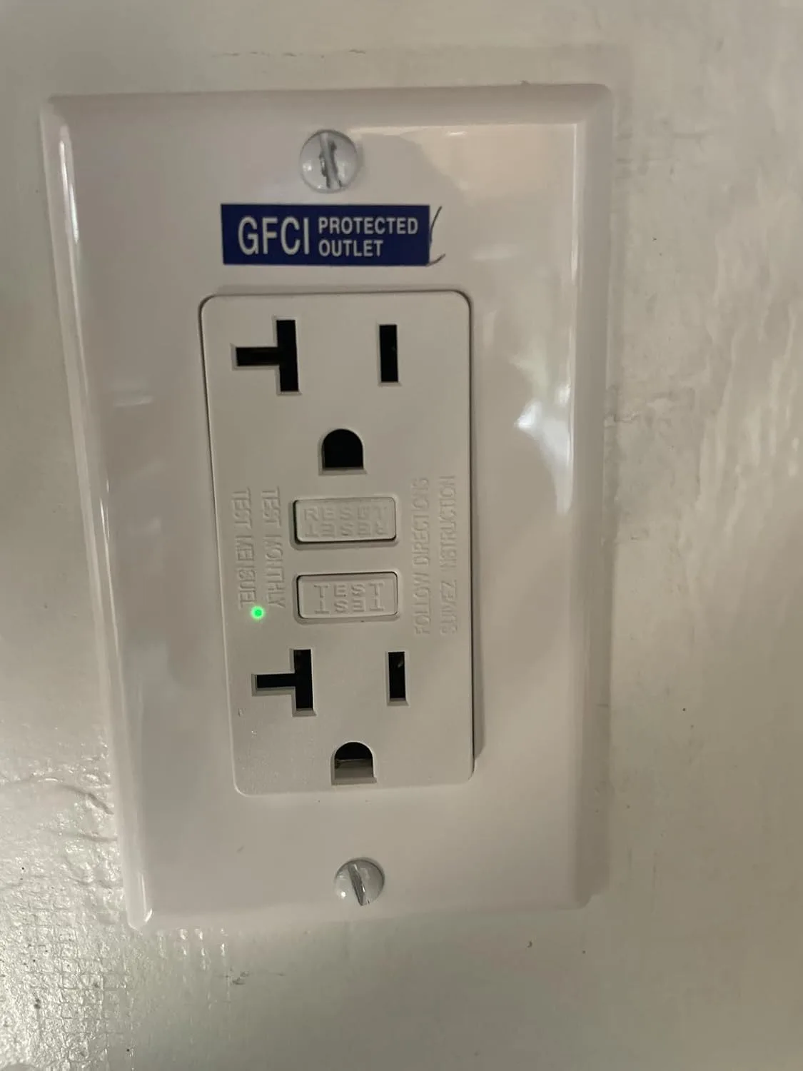 Customer photo of dual function GFCI/AFCI outlet installed in bathroom wall
