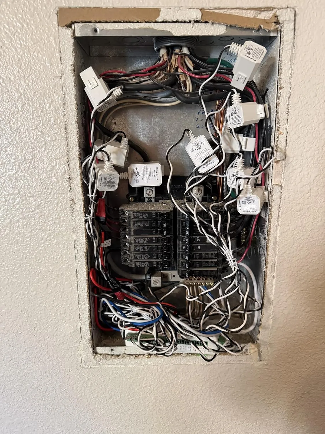 Customer photo of energy monitor display showing real-time power consumption readings on home electrical panel
