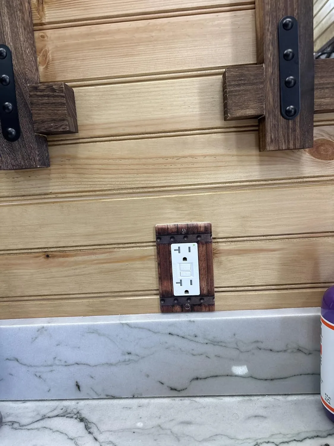 Customer photo of GFCI outlet installed in bathroom wall near sink