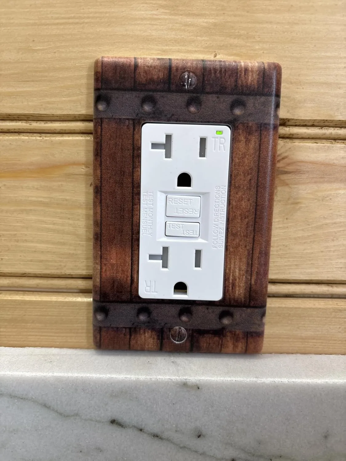Customer photo of dual function GFCI/AFCI outlet installed in bathroom wall