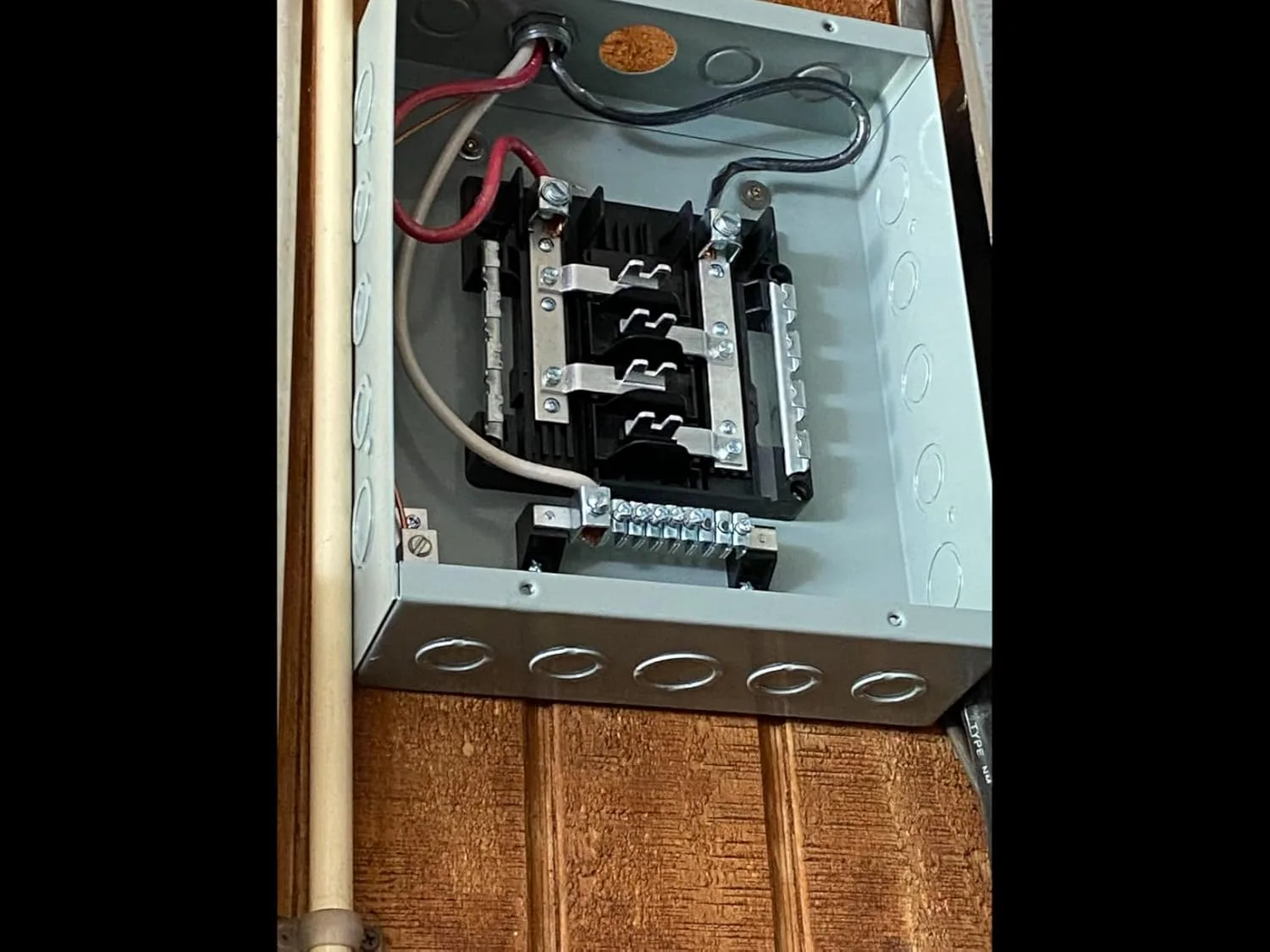 Customer photo of electrical panel upgrade installation showing new breaker box components